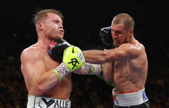 LAS VEGAS, NEVADA - NOVEMBER 02: Canelo Alvarez (L) takes a punch from Sergey Kovalev during their WBO light heavyweight title fight at MGM Grand Garden Arena on November 2, 2019 in Las Vegas, Nevada. Alvarez won the title with an 11th-round knockout. Steve Marcus/Getty Images/AFP