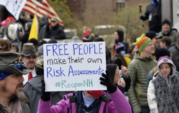 Hundreds of New Hampshire residents rally at the State House, calling on the government to re-open the state for business as the coronavirus shutdown continues, in Concord, New Hampshire, on April 18, 2020. (Photo by Joseph Prezioso / AFP)