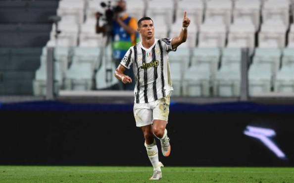 Juventus' Portuguese forward Cristiano Ronaldo celebrates scoring his team's first goal during the UEFA Champions League round of 16 second leg football match between Juventus and Olympique Lyonnais (OL), played behind closed doors due to the spread of the COVID-19 infection, caused by the novel coronavirus, at the Juventus stadium, in Turin , on August 7, 2020. (Photo by Miguel MEDINA / AFP)