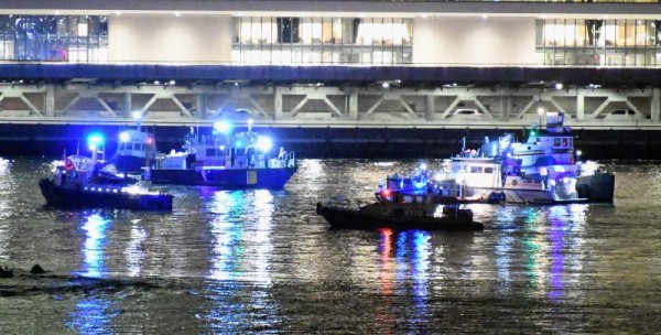 NEW YORK, NY - MARCH 11: Emergency responders work at the scene of a helicopter crash in the East River March 11, 2018 in New York City. According to reports at least two people were killed. Dimitrios Kambouris/Getty Images/AFP