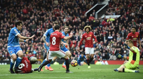 Manchester United's French midfielder Paul Pogba (2nd L) hits his shot at Bournemouth's Polish goalkeeper Artur Boruc (R) as he tries to convert a late chance during the English Premier League football match between Manchester United and Bournemouth at Old Trafford in Manchester, north west England, on March 4, 2017.The game finished 1-1. / AFP PHOTO / Oli SCARFF / RESTRICTED TO EDITORIAL USE. No use with unauthorized audio, video, data, fixture lists, club/league logos or 'live' services. Online in-match use limited to 75 images, no video emulation. No use in betting, games or single club/league/player publications. /