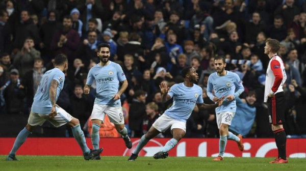 Manchester City's English midfielder Raheem Sterling (C) celebrates scoring the opening goal during the UEFA Champions League Group F football match between Manchester City and Feyenoord at the Etihad Stadium in Manchester, north west England, on November 21, 2017. / AFP PHOTO / Paul ELLIS