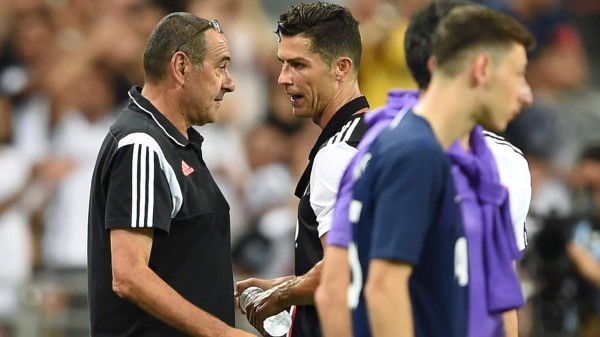 Juventus' Cristiano Ronaldo (C) talks to manager Maurizio Sarri (L) after being substituted during the International Champions Cup football match between Juventus and Tottenham Hotspur in Singapore on July 21, 2019. (Photo by Roslan RAHMAN / AFP)