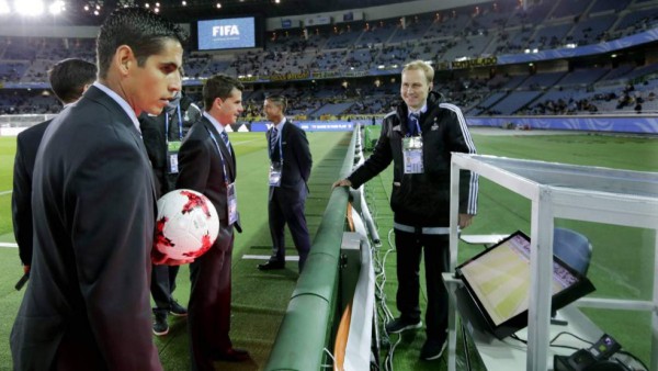 Paraguayan referee Juan Gabriel Benitez consults the VAR as he conducts the closed-door 2022 FIFA World Cup South American qualifier football match between Brazil and Venezuela at Morumbi Stadium in Sao Paulo, Brazil, on November 13, 2020. (Photo by FERNANDO BIZERRA / various sources / AFP)