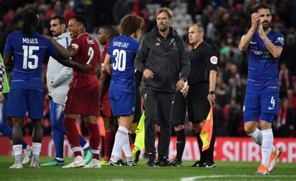 Liverpool's German manager Jurgen Klopp congratulates the Cheslea players following the English League Cup third round football match between Liverpool and Chelsea at Anfield in Liverpool, north west England on September 26, 2018. / AFP PHOTO / Paul ELLIS / RESTRICTED TO EDITORIAL USE. No use with unauthorized audio, video, data, fixture lists, club/league logos or 'live' services. Online in-match use limited to 120 images. An additional 40 images may be used in extra time. No video emulation. Social media in-match use limited to 120 images. An additional 40 images may be used in extra time. No use in betting publications, games or single club/league/player publications. /
