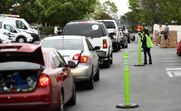 SAN RAFAEL, CALIFORNIA - APRIL 18: The line of cars for the drive thru food pick up at the San Francisco-Marin Food Bank was over eight blocks long on April 18, 2020 in San Rafael, California. The Food Bank is offering drive thru pickup on Saturday mornings during the Coronavirus (COVID-19) pandemic. Ezra Shaw/Getty Images/AFP