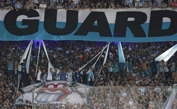 Fans of Racing Club cheer for their team during the Argentina First Division Superliga football match against Belgrano at the Presidente Juan Domingo Peron stadium in Avellaneda, near Buenos Aires, on March 16, 2019. (Photo by Alejandro PAGNI / AFP)