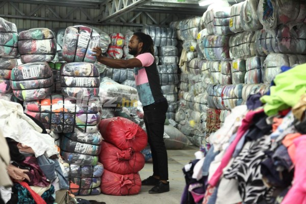 Así es el trabajo de Roy Smith cargando bultos y seleccionando ropa en una bodega de ropa