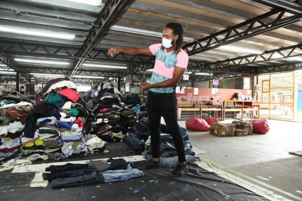 Así es el trabajo de Roy Smith cargando bultos y seleccionando ropa en una bodega de ropa