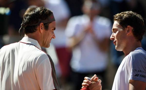 Switzerland's Roger Federer (L) and Norway's Casper Ruud shake hands at the end of their men's singles third round match on day six of The Roland Garros 2019 French Open tennis tournament in Paris on May 31, 2019. (Photo by Christophe ARCHAMBAULT / AFP)